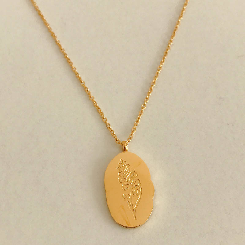 Halsband med hängsmycke i guld och födelseblomma