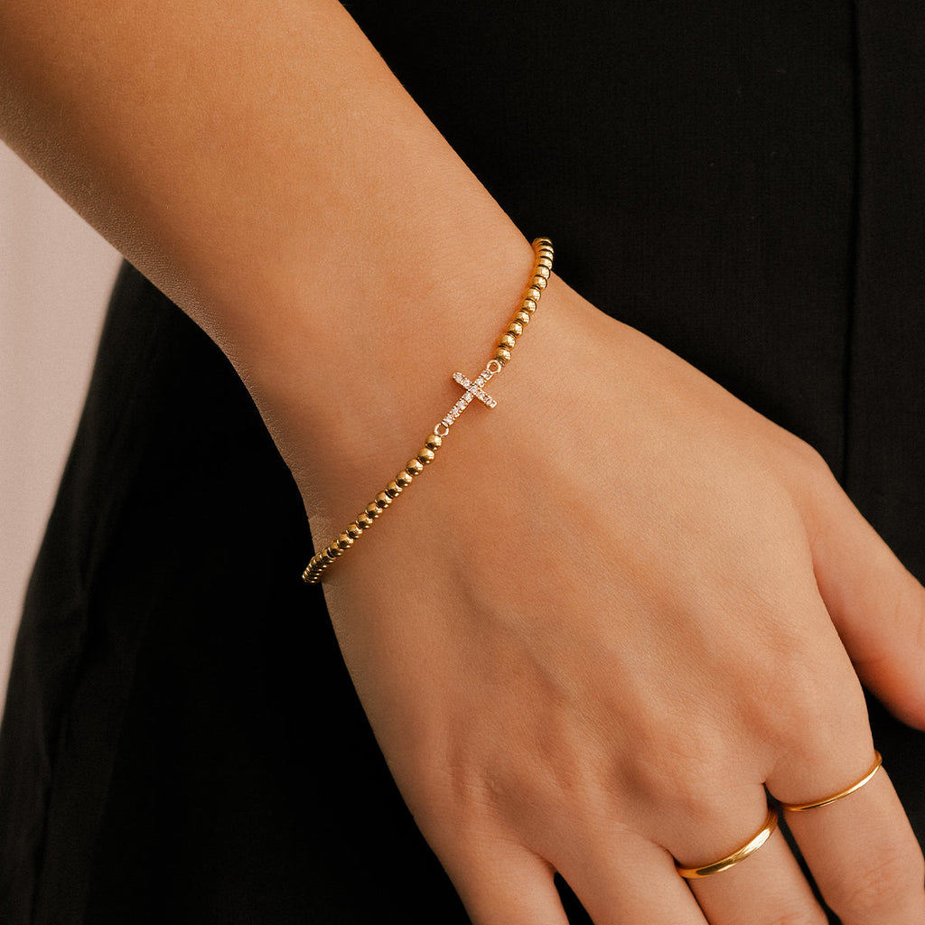 Pulseira Elástica com Cruz e Contas Douradas